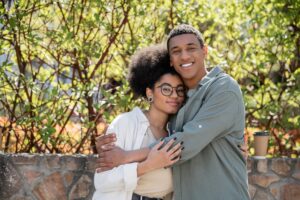 smiling-african-american-man-hugging-girlfriend-an-2023-11-27-05-03-36-utc